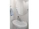 Small bathroom with pedestal sink, round mirror, and modern fixtures at 5100 Park Creek Ave, North Charleston, SC 29418