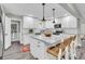 Modern kitchen with white cabinets, large island, and hardwood floors at 561 Saint Andrews Blvd, Charleston, SC 29407