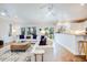 Open floor plan living room and kitchen, featuring hardwood floors and white cabinetry at 65 Ocean Point Dr, Isle of Palms, SC 29451