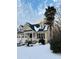 Charming yellow house with dark grey roof, palm trees, and snow-covered yard at 892 Hunt Club Run, Charleston, SC 29414