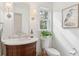 Charming bathroom with a marble vanity, toilet, and decorative artwork at 935 Paul Revere Dr, Charleston, SC 29412