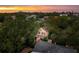 Pink house nestled among trees with city skyline in the distance at 14 1/2 Murray Blvd, Charleston, SC 29401