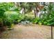 Peaceful brick patio with lush tropical plants and seating area at 14 1/2 Murray Blvd, Charleston, SC 29401