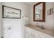 Clean bathroom with vanity, mirror, and neutral colors at 14 1/2 Murray Blvd, Charleston, SC 29401