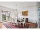 Bright dining room with hardwood floors, French doors, and a formal dining table at 14 1/2 Murray Blvd, Charleston, SC 29401