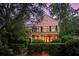 Two-story pink house with balcony and landscaped yard at 14 1/2 Murray Blvd, Charleston, SC 29401