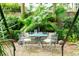 Charming garden with brick patio, lush plants, and a metal bistro set at 14 1/2 Murray Blvd, Charleston, SC 29401