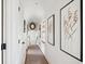 Light-filled hallway with artwork and carpeted floors at 14 1/2 Murray Blvd, Charleston, SC 29401