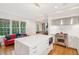 Bright kitchen boasts white cabinets, stainless steel appliances, and a large island at 14 1/2 Murray Blvd, Charleston, SC 29401
