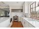 Clean, white kitchen with stainless steel appliances and hardwood floors at 14 1/2 Murray Blvd, Charleston, SC 29401
