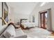 Spacious main bedroom with a plush bed, sitting area, and French doors to a deck at 14 1/2 Murray Blvd, Charleston, SC 29401