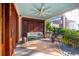 Covered porch with wooden seating and ceiling fan at 14 1/2 Murray Blvd, Charleston, SC 29401