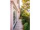 Peaceful side yard with a wooden walkway and greenery at 14 1/2 Murray Blvd, Charleston, SC 29401