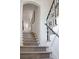 Stylish staircase with a neutral carpet runner and wrought iron railing at 14 1/2 Murray Blvd, Charleston, SC 29401