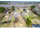 Aerial view of a quiet residential area with houses surrounded by trees and a clear blue sky above at 141 Nottingham Ln, Yemassee, SC 29945