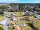 Neighborhood view with single-Gathering homes, green lawns, mature trees, and multiple cars on driveways at 141 Nottingham Ln, Yemassee, SC 29945