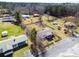 Aerial view of multiple homes, green lawns, trees, and a nearby road at 141 Nottingham Ln, Yemassee, SC 29945