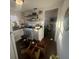 Kitchen with white appliances and an adjoining room, plus hardwood flooring at 141 Nottingham Ln, Yemassee, SC 29945