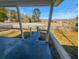 Inviting porch view with a concrete floor, overlooking a green lawn, street, and trees under a blue sky at 141 Nottingham Ln, Yemassee, SC 29945
