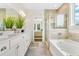 Main bathroom with double vanity, soaking tub, and separate shower at 143 Winding Grove Ln, Moncks Corner, SC 29461