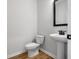 Elegant powder room featuring a pedestal sink, modern fixtures, and stylish design elements at 143 Winding Grove Ln, Moncks Corner, SC 29461