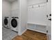 Convenient laundry room equipped with modern washer, dryer, and custom storage solutions at 143 Winding Grove Ln, Moncks Corner, SC 29461