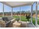 Relaxing screened porch with comfortable seating, views of backyard, and decorative plants at 143 Winding Grove Ln, Moncks Corner, SC 29461