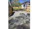 Gravel driveway leads to a fenced backyard and charming home with a small staircase at 161 Stratton Dr, North Charleston, SC 29420