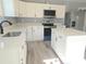 Modern kitchen with white cabinets, quartz countertops, and an island at 161 Stratton Dr, North Charleston, SC 29420