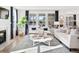 Bright living room with a white sofa, fireplace, and large windows at 1655 Siloh St # 488, Mount Pleasant, SC 29466
