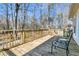 Wooden deck with metal chairs and a small table, overlooking a wooded backyard at 174 Winding Rock Rd, Goose Creek, SC 29445