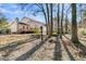 House backyard with trees and leaf covered ground at 174 Winding Rock Rd, Goose Creek, SC 29445