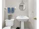 Small bathroom with pedestal sink, toilet, and a round mirror at 174 Winding Rock Rd, Goose Creek, SC 29445