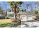 Two-story house with green shutters, palm tree, and a two-car garage at 174 Winding Rock Rd, Goose Creek, SC 29445