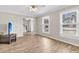 Living room with hardwood floors, large windows and a view of the staircase at 174 Winding Rock Rd, Goose Creek, SC 29445