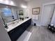 Double vanity bathroom with navy cabinets and quartz counters at 178 Wappoo Trace Ln, Summerville, SC 29486