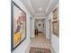Long hallway with hardwood floors, artwork, and a decorative rug at 178 Wappoo Trace Ln, Summerville, SC 29486