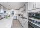Modern kitchen with white cabinets, quartz countertops, and stainless steel appliances at 178 Wappoo Trace Ln, Summerville, SC 29486