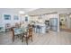 Modern kitchen and dining area with white cabinetry and a glass dining table at 178 Wappoo Trace Ln, Summerville, SC 29486