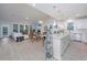 Open concept kitchen and living area with white cabinets, a large island, and hardwood floors at 178 Wappoo Trace Ln, Summerville, SC 29486