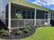 Screened porch with landscaping and a view of the backyard at 178 Wappoo Trace Ln, Summerville, SC 29486