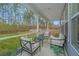 Relaxing screened porch with outdoor seating and wooded views at 178 Wappoo Trace Ln, Summerville, SC 29486