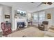 Cozy living room with fireplace, hardwood floors, and large windows at 203 Oak View Way, Summerville, SC 29483