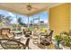 Relaxing screened porch with wicker furniture at 203 Oak View Way, Summerville, SC 29483