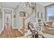 Light-filled staircase with wooden railing and cozy sitting area at 203 Oak View Way, Summerville, SC 29483
