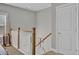 Upstairs hallway with railing and pool cue storage at 203 Oak View Way, Summerville, SC 29483