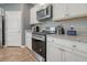 Modern kitchen with white cabinets and stainless steel appliances at 219 Greenwich Dr, Summerville, SC 29486