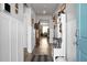 Long entry hall with coat rack, decorative pillows, and blue door at 221 Rubles Ln, Moncks Corner, SC 29461