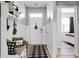 Bright entryway with bench, coat rack, and black and white rug at 221 Rubles Ln, Moncks Corner, SC 29461