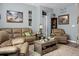 Relaxing living room featuring neutral-toned leather sofas and a coffee table at 221 Rubles Ln, Moncks Corner, SC 29461